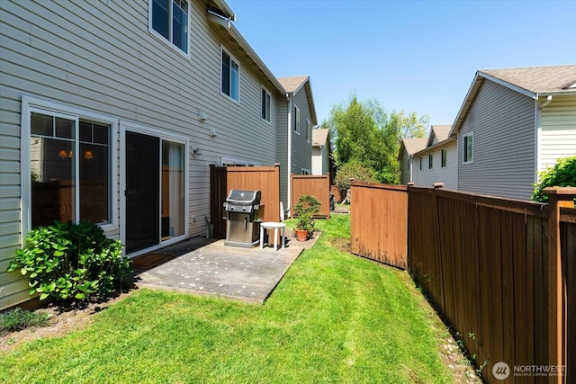 view of yard with a patio, fence, and a residential view