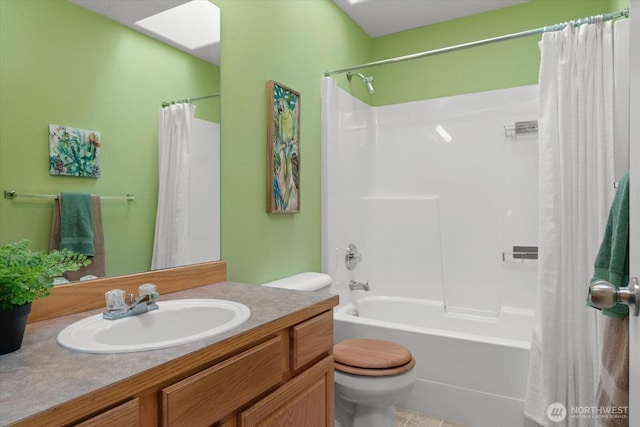 full bath featuring vanity, toilet, and shower / tub combo