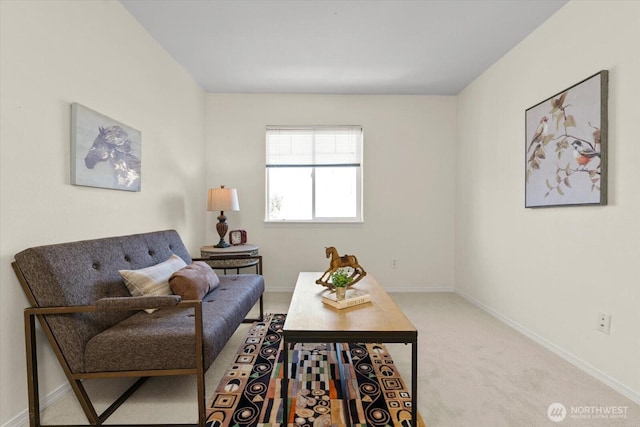 living area featuring carpet flooring and baseboards