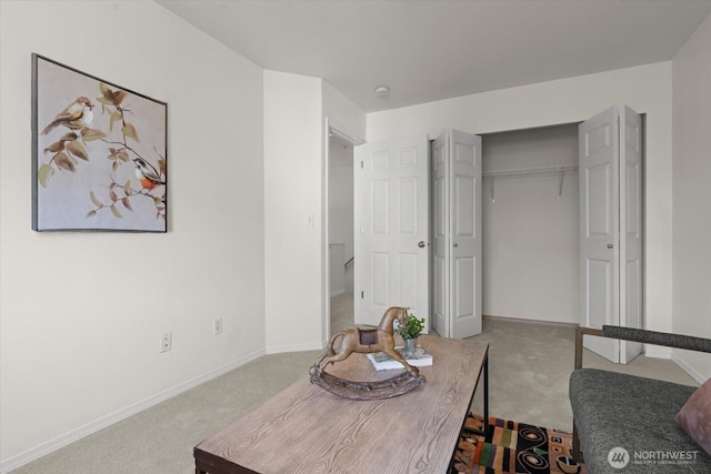 carpeted bedroom with baseboards and a closet