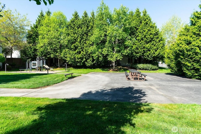 view of community with a lawn and playground community