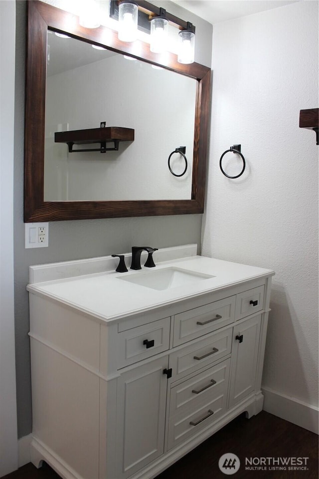 bathroom with vanity and baseboards