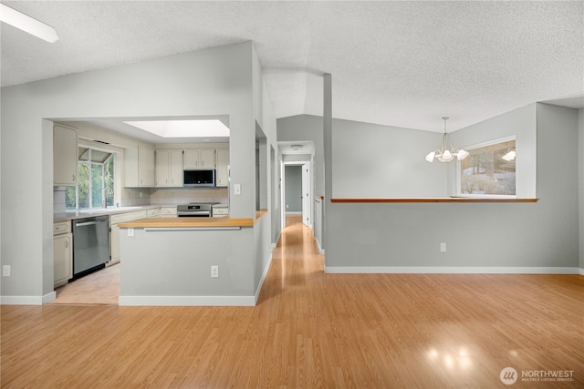 315 Point Fosdick Pl NW, Gig Harbor, WA 98335 - kitchen featuring butcher block counters, light wood finished floors, appliances with stainless steel finishes, and a chandelier