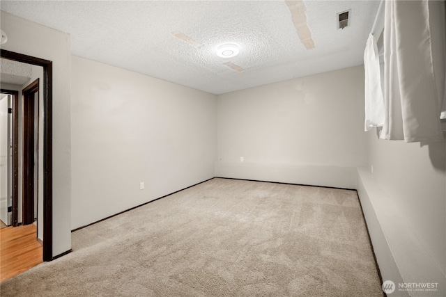 315 Point Fosdick Pl NW, Gig Harbor, WA 98335 - carpeted spare room with visible vents and a textured ceiling