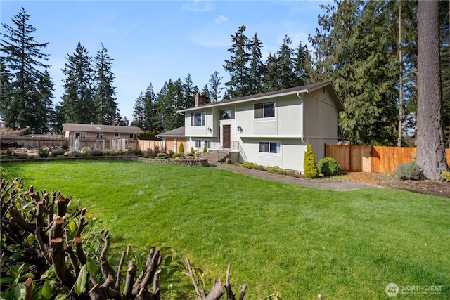 315 Point Fosdick Pl NW, Gig Harbor, WA 98335 - raised ranch featuring a chimney, a front yard, and fence