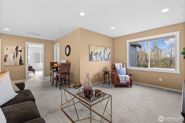 carpeted living area featuring recessed lighting, visible vents, and baseboards