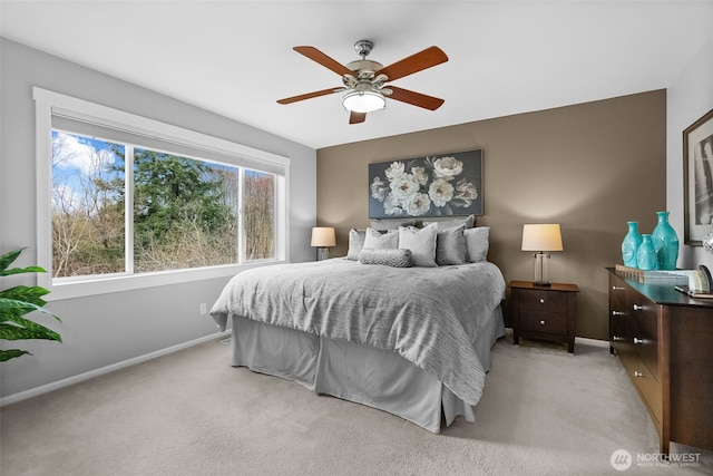 bedroom featuring ceiling fan, baseboards, and light carpet