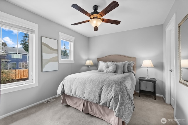 bedroom with carpet flooring, ceiling fan, baseboards, and visible vents