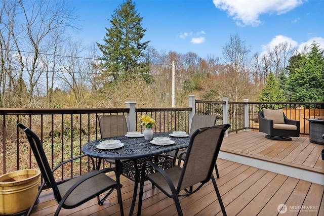 wooden terrace featuring outdoor dining space