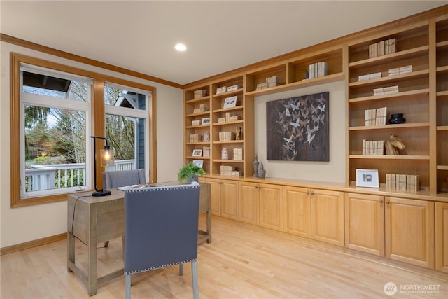 office with crown molding, light wood-style floors, and baseboards