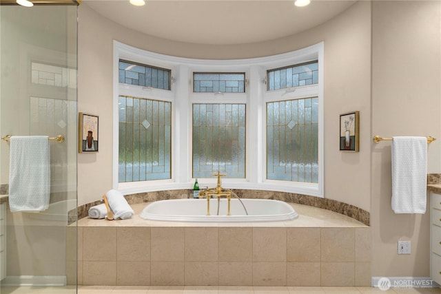 bathroom with a bath, recessed lighting, and a shower