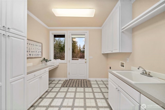 clothes washing area featuring washer hookup, a sink, cabinet space, crown molding, and hookup for an electric dryer