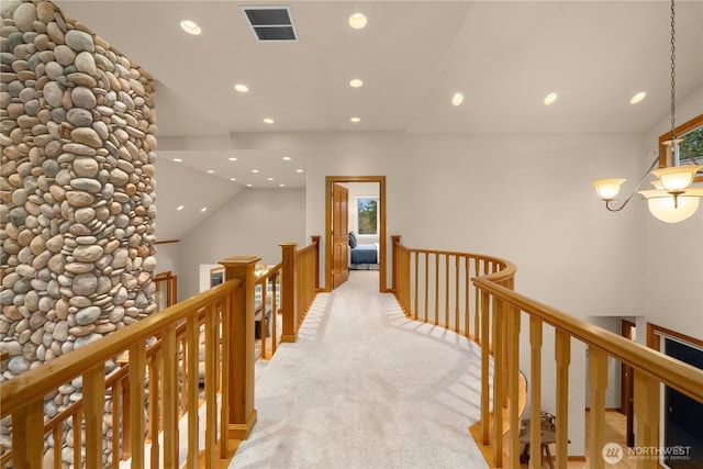 corridor with recessed lighting, visible vents, an upstairs landing, and light colored carpet