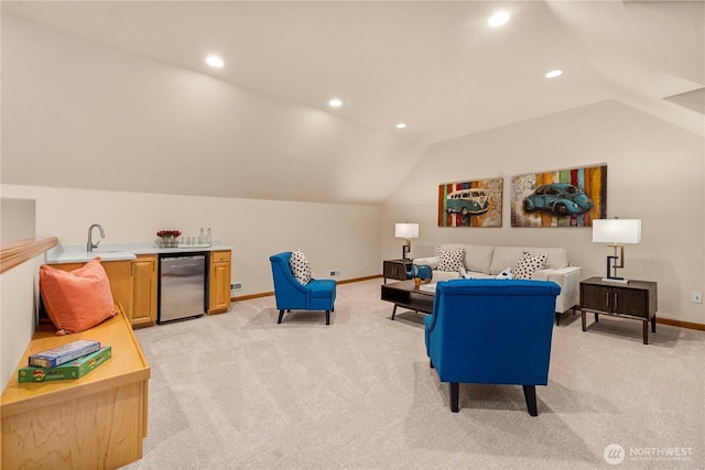 living area featuring indoor wet bar, vaulted ceiling, light colored carpet, and baseboards