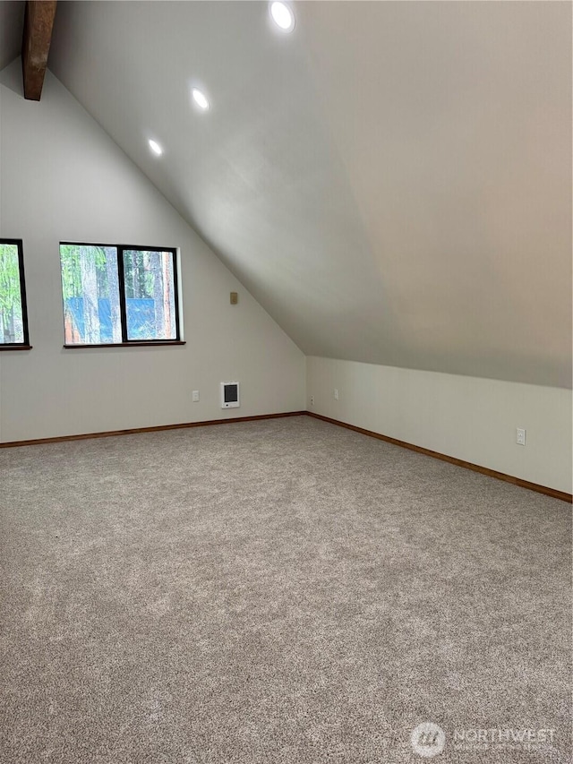 bonus room with carpet flooring, baseboards, visible vents, and vaulted ceiling with beams