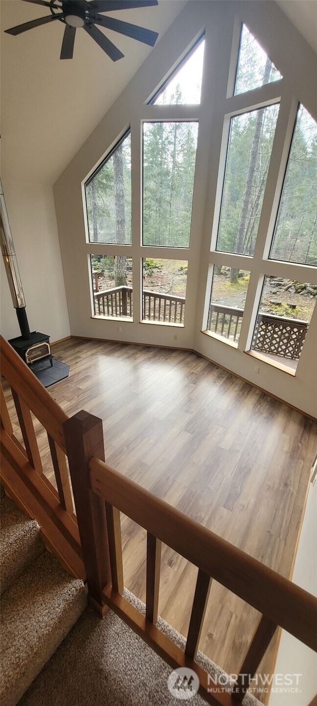 unfurnished sunroom with plenty of natural light, lofted ceiling, and a ceiling fan