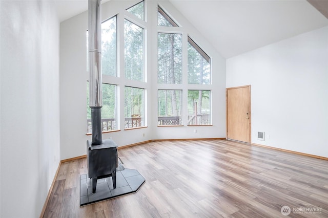 213 Crescent Beach Dr, Packwood, WA 98361 - unfurnished living room with plenty of natural light, visible vents, high vaulted ceiling, and wood finished floors