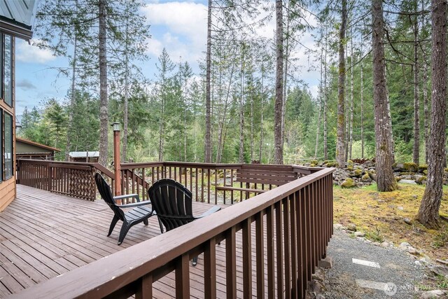 213 Crescent Beach Dr, Packwood, WA 98361 - wooden deck featuring a view of trees