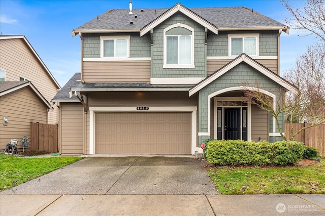 view of front of property featuring a shingled roof, an attached garage, concrete driveway, and fence