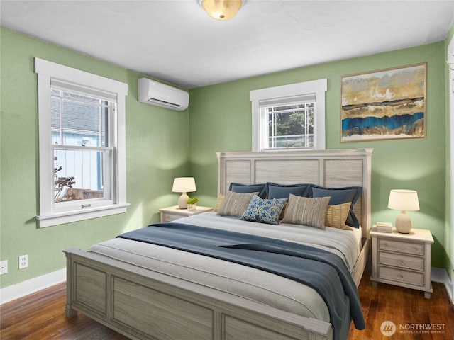 bedroom with dark wood finished floors, baseboards, and a wall mounted AC