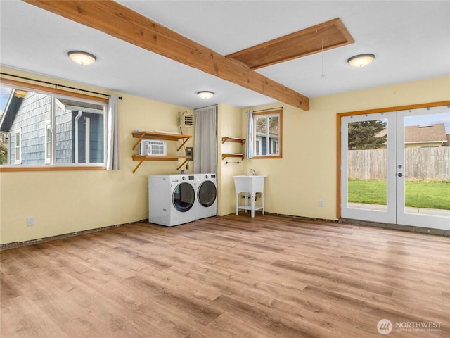 washroom with attic access, separate washer and dryer, french doors, wood finished floors, and a sink