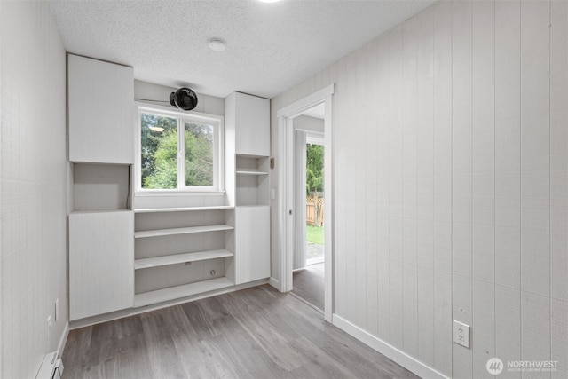 interior space featuring a baseboard radiator and wood finished floors