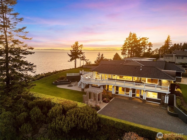 5685 Nakat Way, Blaine, WA 98230 - back of property at dusk with a patio area, a deck with water view, driveway, a yard, and stairway
