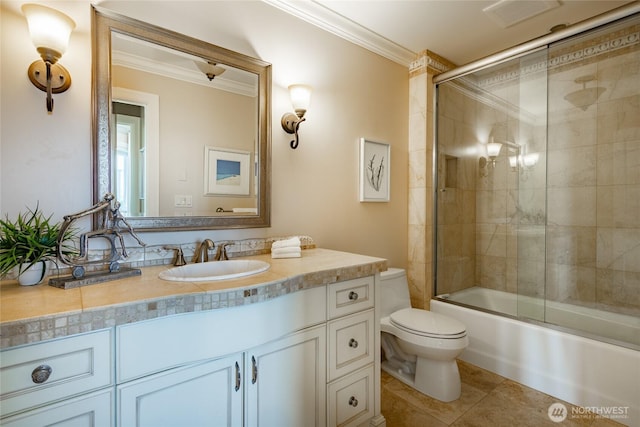 5685 Nakat Way, Blaine, WA 98230 - full bath featuring crown molding, toilet, vanity, tile patterned floors, and bath / shower combo with glass door