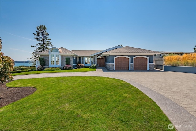 5685 Nakat Way, Blaine, WA 98230 - view of front facade with stone siding, decorative driveway, an attached garage, a front lawn, and roof mounted solar panels
