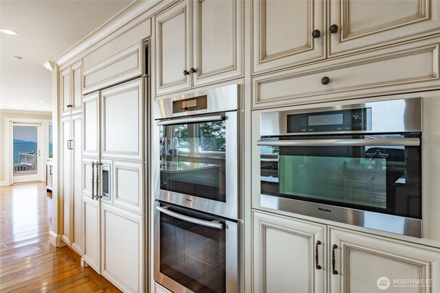 5685 Nakat Way, Blaine, WA 98230 - kitchen with cream cabinets, double oven, light wood-type flooring, and recessed lighting