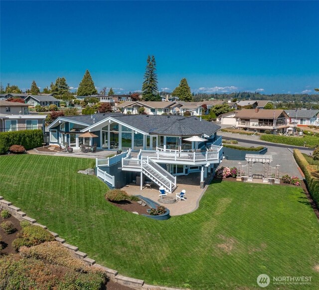 5685 Nakat Way, Blaine, WA 98230 - rear view of property featuring stairway, a patio area, a residential view, a wooden deck, and a lawn