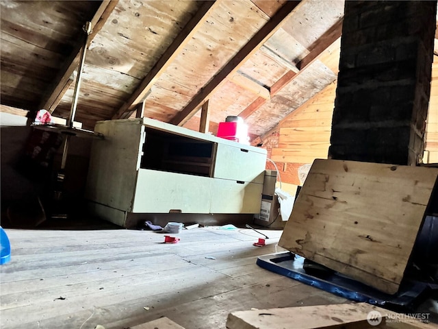 interior space with wooden walls, wood ceiling, and lofted ceiling with beams