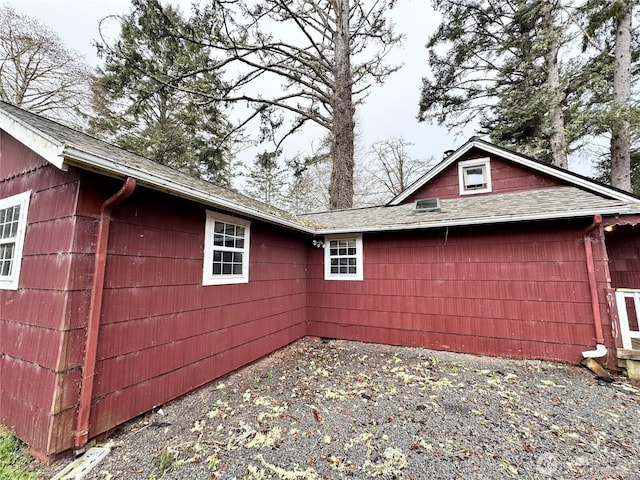 view of home's exterior with a shingled roof