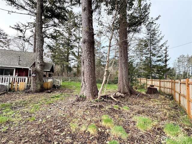 view of yard featuring fence and a wooden deck