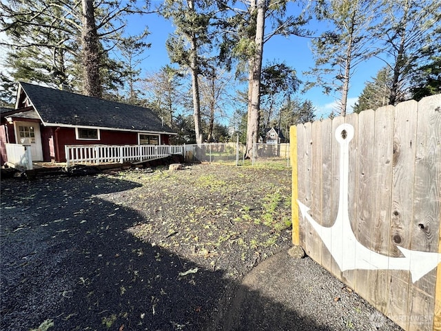 view of yard with a wooden deck and fence