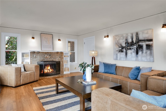 living area with a fireplace and wood finished floors