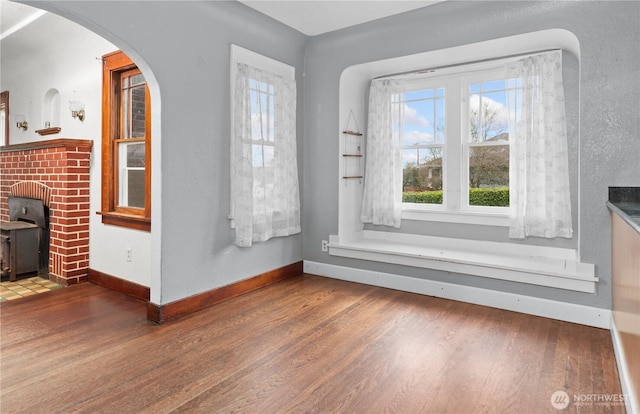 interior space featuring baseboards and hardwood / wood-style floors