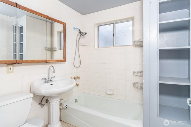 full bath featuring backsplash, toilet, tile walls, and bathing tub / shower combination