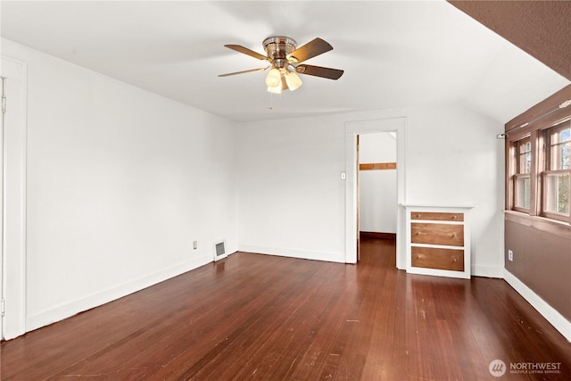 unfurnished room with visible vents, lofted ceiling, hardwood / wood-style floors, baseboards, and ceiling fan