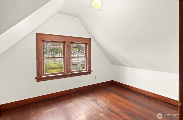 bonus room with vaulted ceiling, baseboards, and hardwood / wood-style floors