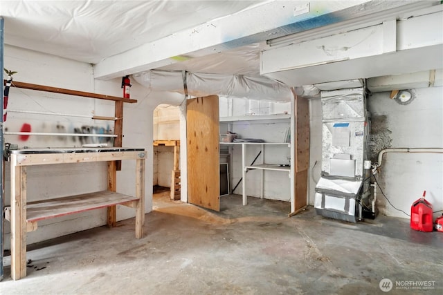 unfinished basement featuring heating unit