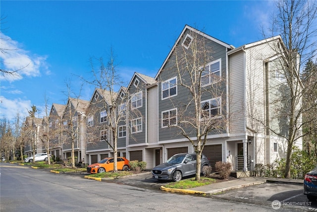 view of property featuring a garage and a residential view