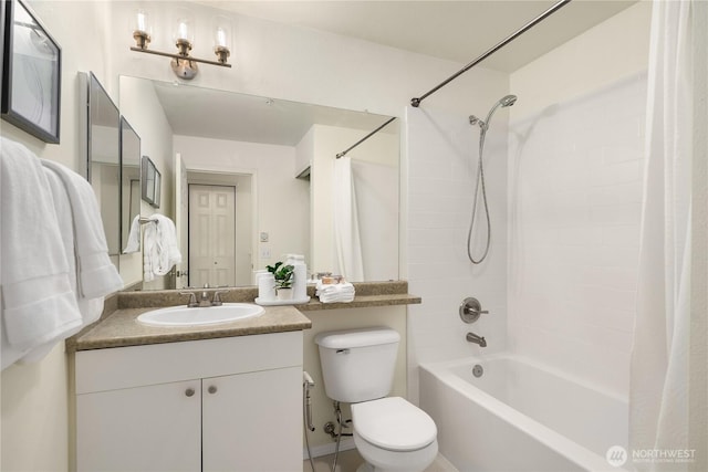 full bathroom featuring toilet, shower / bath combo with shower curtain, and vanity