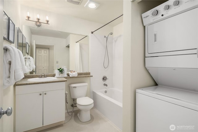 full bath with visible vents, toilet, shower / tub combo, stacked washer / dryer, and vanity