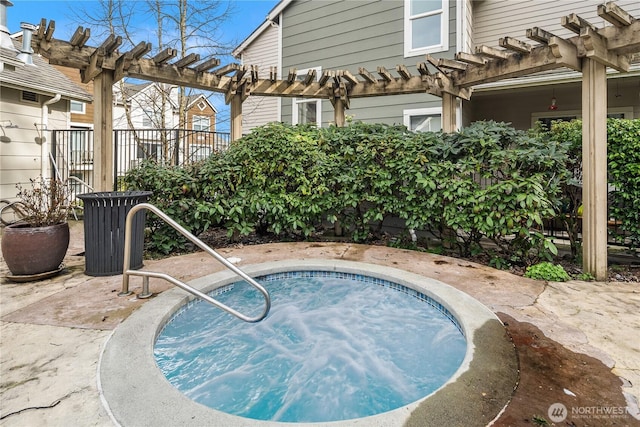 view of swimming pool with fence, an in ground hot tub, and a pergola