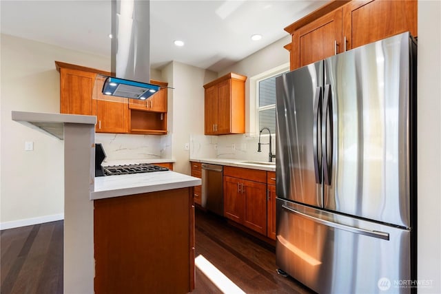 kitchen featuring decorative backsplash, appliances with stainless steel finishes, island range hood, and light countertops