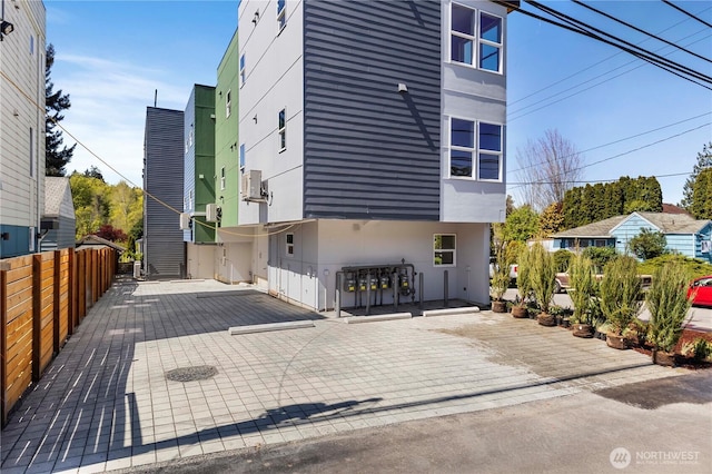 view of home's exterior featuring stucco siding and fence