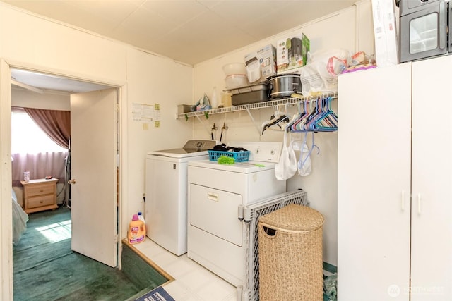 clothes washing area with washer and dryer, laundry area, and tile patterned floors