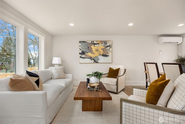 living room featuring a wall mounted air conditioner, baseboards, wood finished floors, and recessed lighting