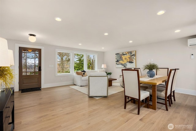 dining room with recessed lighting, baseboards, and light wood-style floors